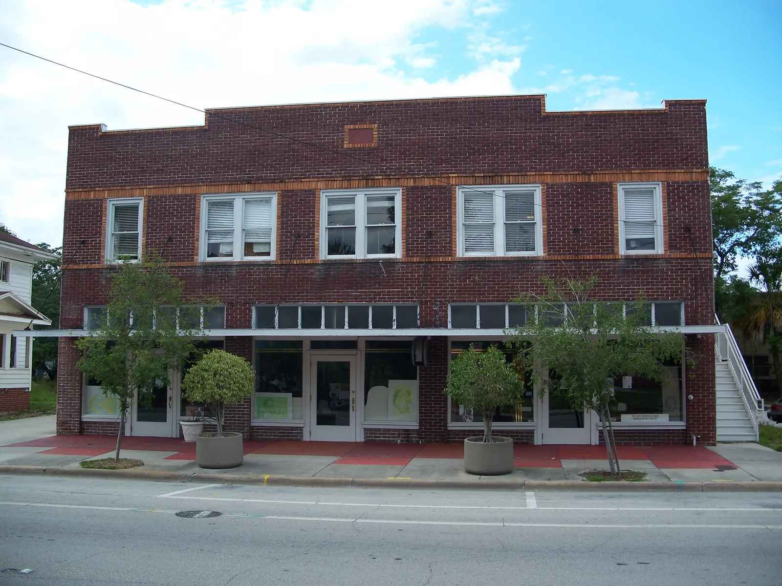 The two-storey brick front of the former Wells'Built Hotel on West South Street in Orlando's Parramore district, now a museum, with shopfront windows along the ground floor