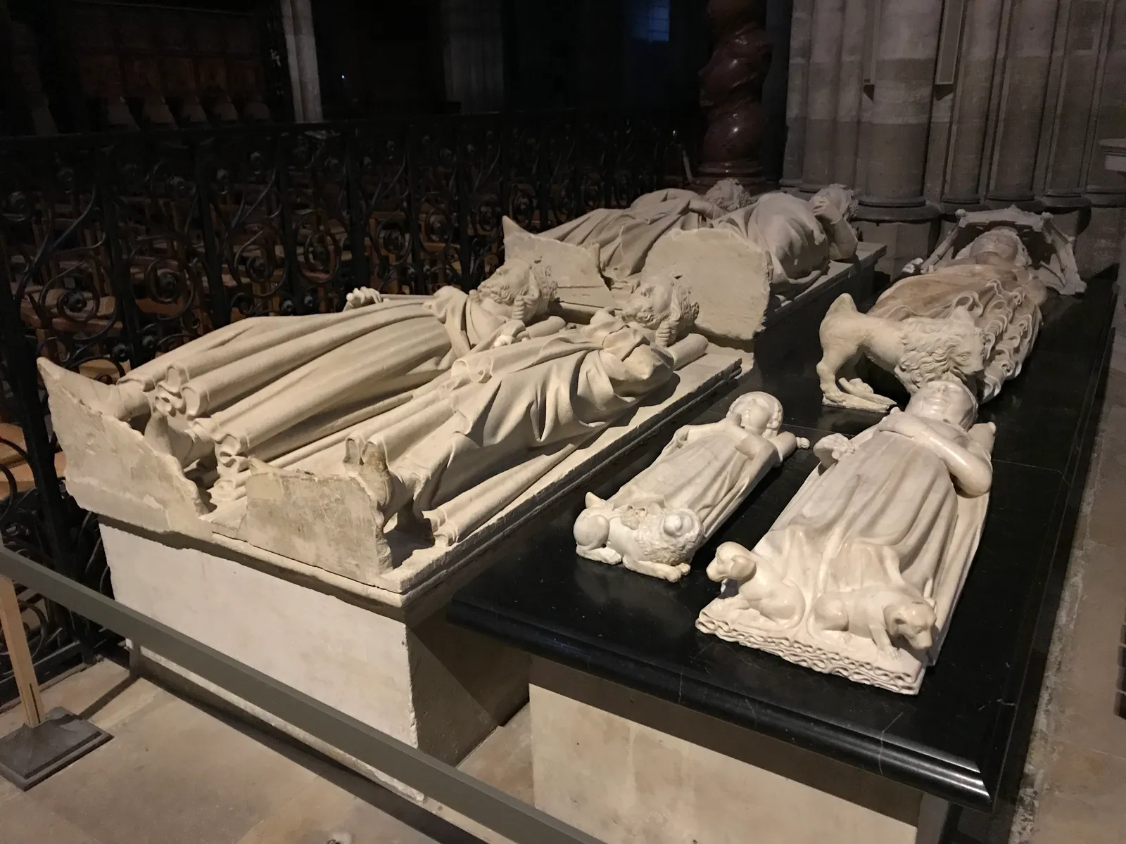 Carved stone effigies of French kings and queens lying on their tombs inside the Basilica of Saint-Denis