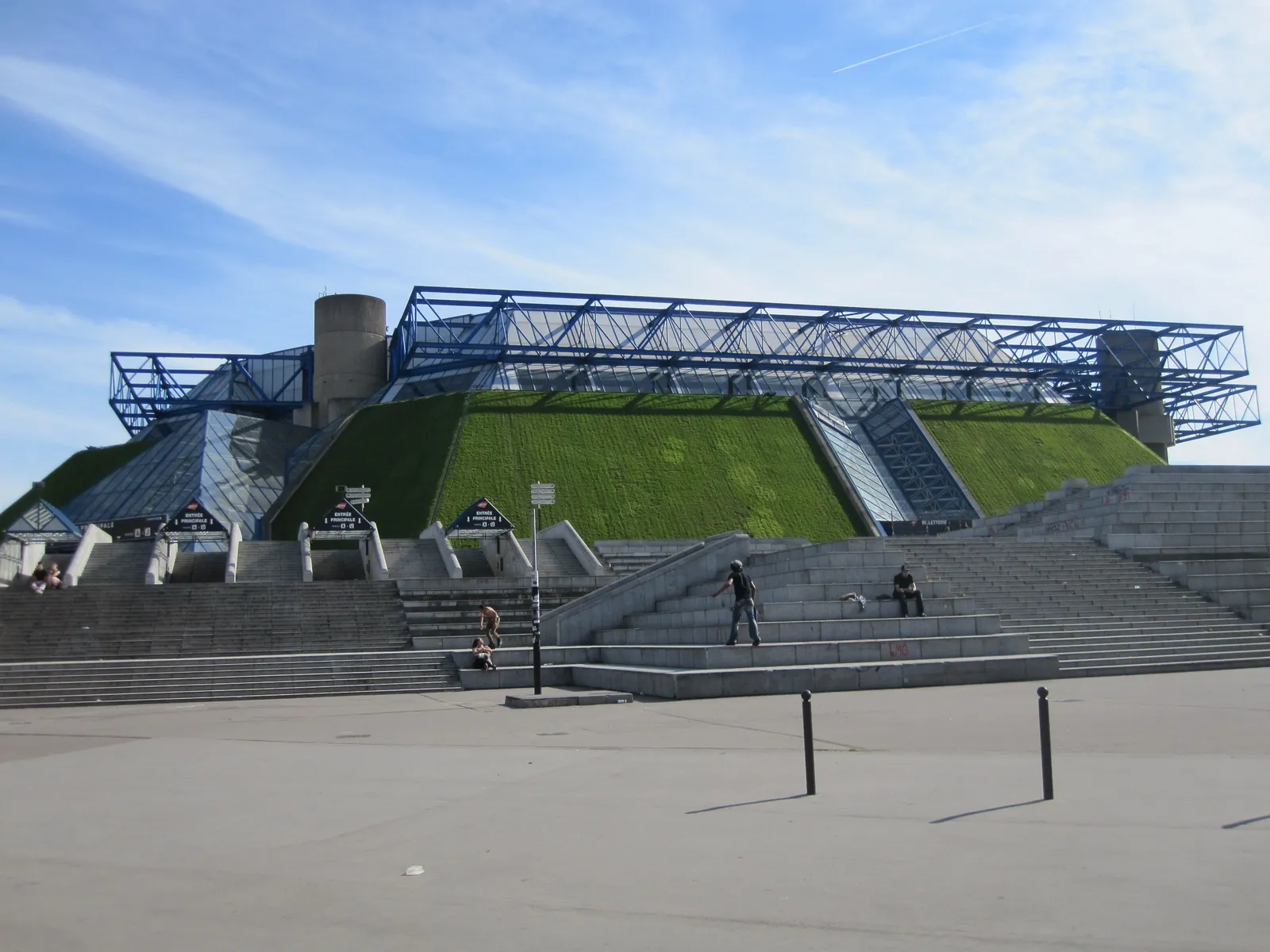 The grass-covered sloped roof of the Bercy Arena (Accor Arena) rising above its concrete plaza in Paris