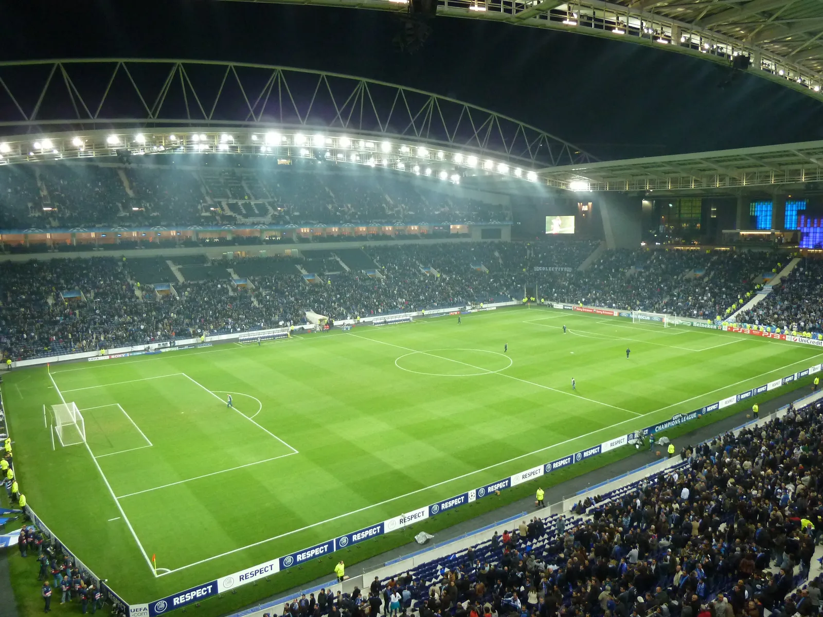 The floodlit pitch and packed stands of the Estádio do Dragão in Porto during an evening match