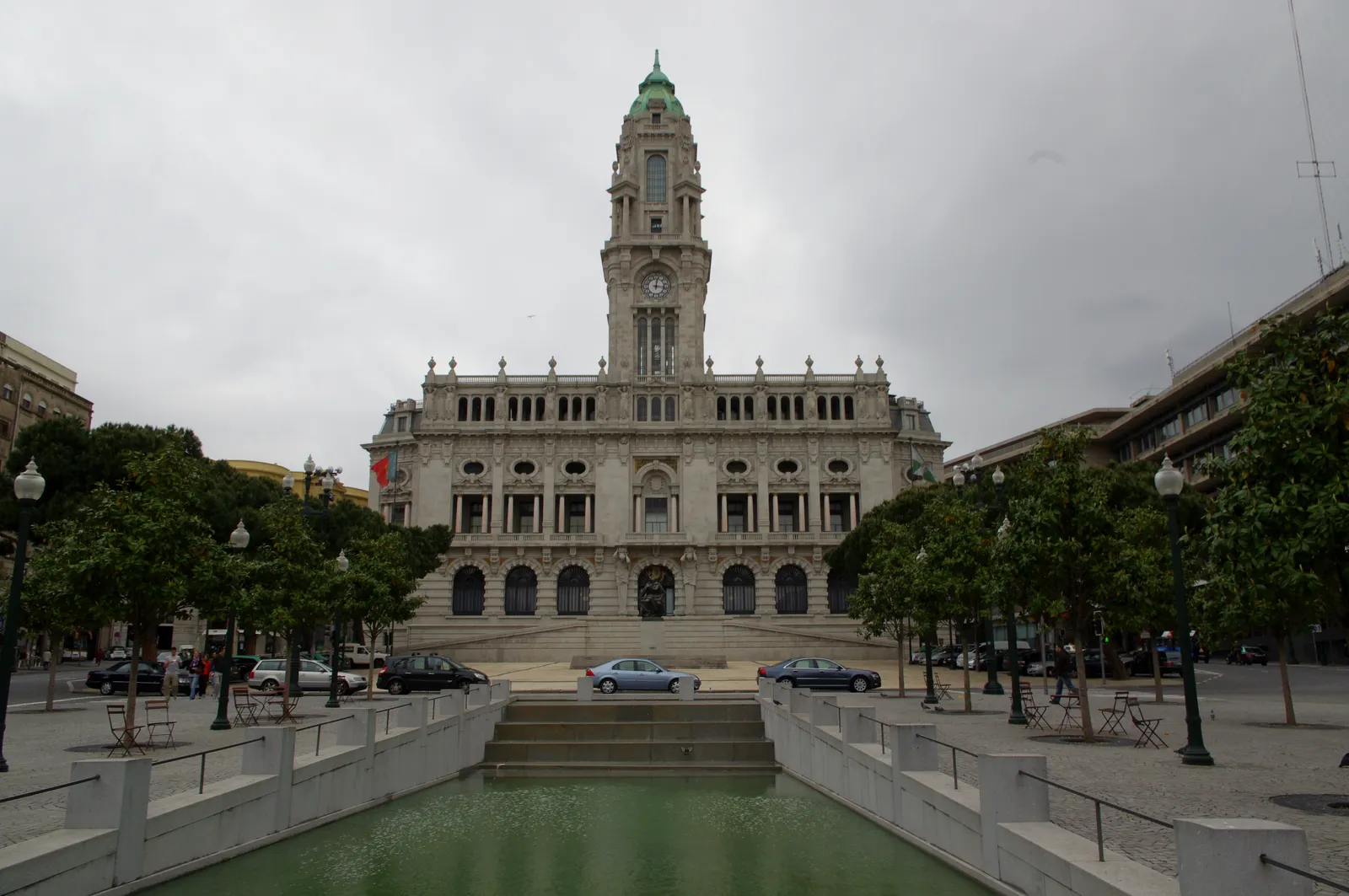 Porto's city hall building and clock tower at the head of Avenida dos Aliados, seen across the avenue's reflecting pool