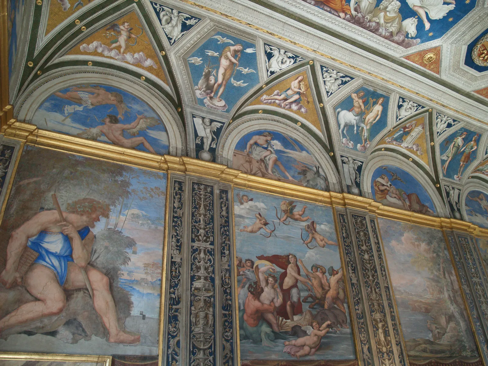 The Loggia of Galatea at Villa Farnesina in Rome, its walls and vaulted ceiling covered in Renaissance frescoes of mythological figures, with Raphael's Triumph of Galatea on a shell drawn by dolphins in the central panel