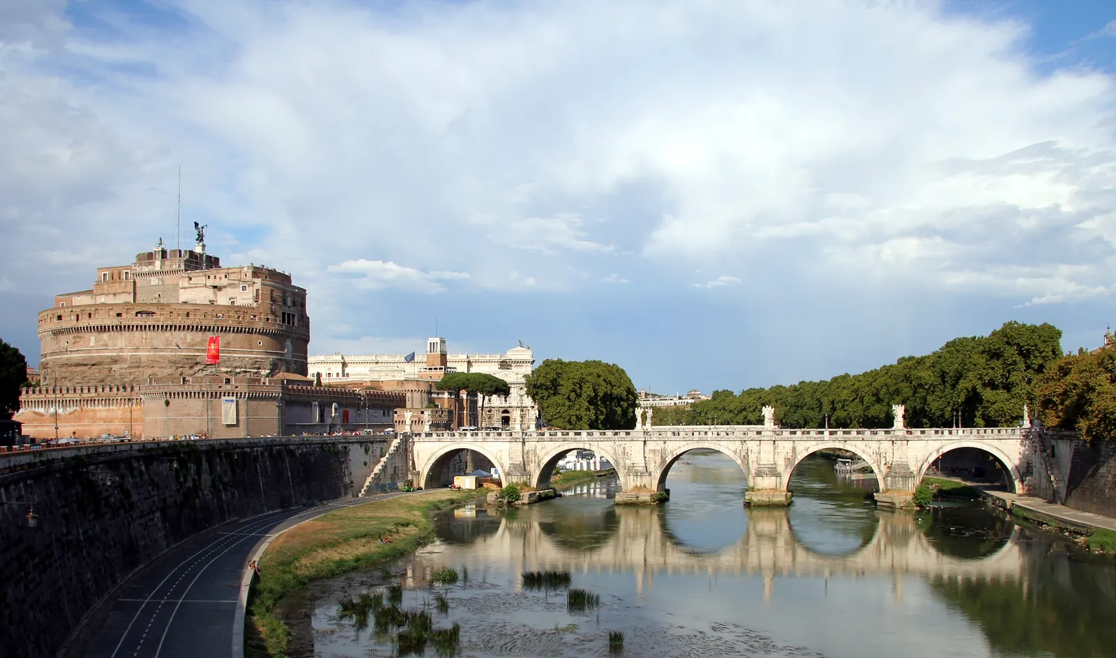 Castel Sant'Angelo in Rome beside the Tiber river, with the Ponte Sant'Angelo bridge crossing in front of it