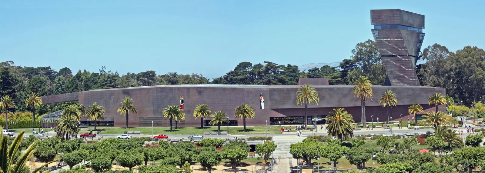 The de Young Museum in Golden Gate Park, a long low copper-clad building with its twisting observation tower rising at one end above palms and clipped hedges