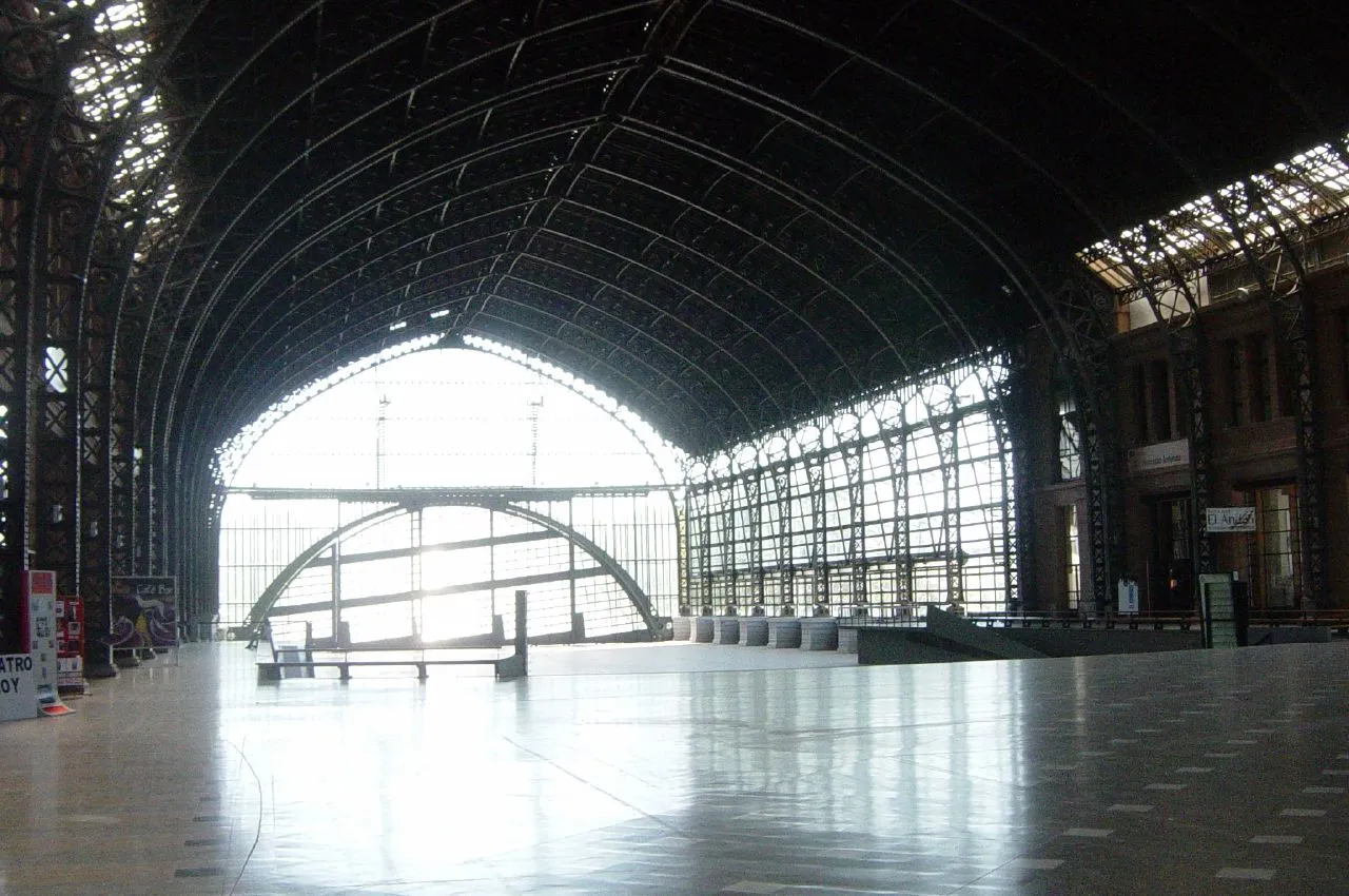 The great glazed steel vault of Estación Mapocho in Santiago seen from inside the empty former platform hall, with light flooding through the end screen