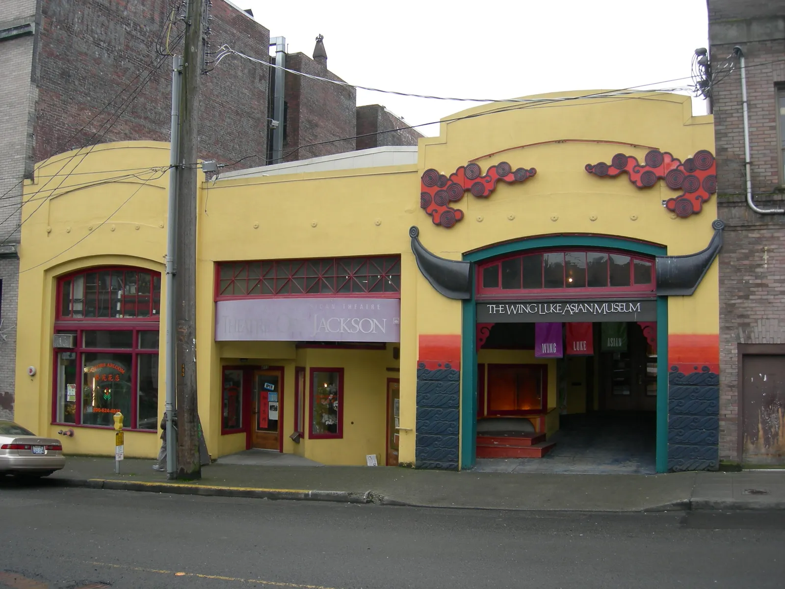 The yellow street frontage of the Wing Luke Museum in Seattle's East Kong Yick Building, with its arched entrance and painted red and black signage