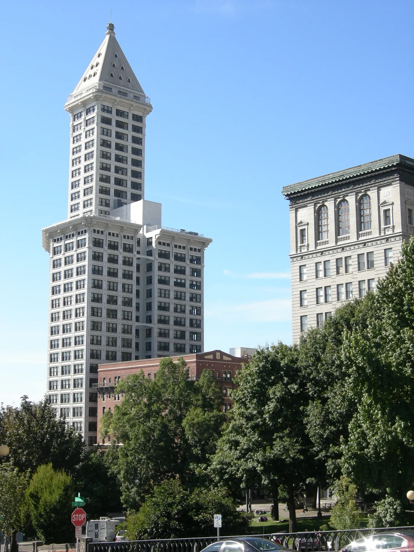 Seattle's white terracotta Smith Tower with its stepped shaft and pyramid cap, seen from street level in Pioneer Square