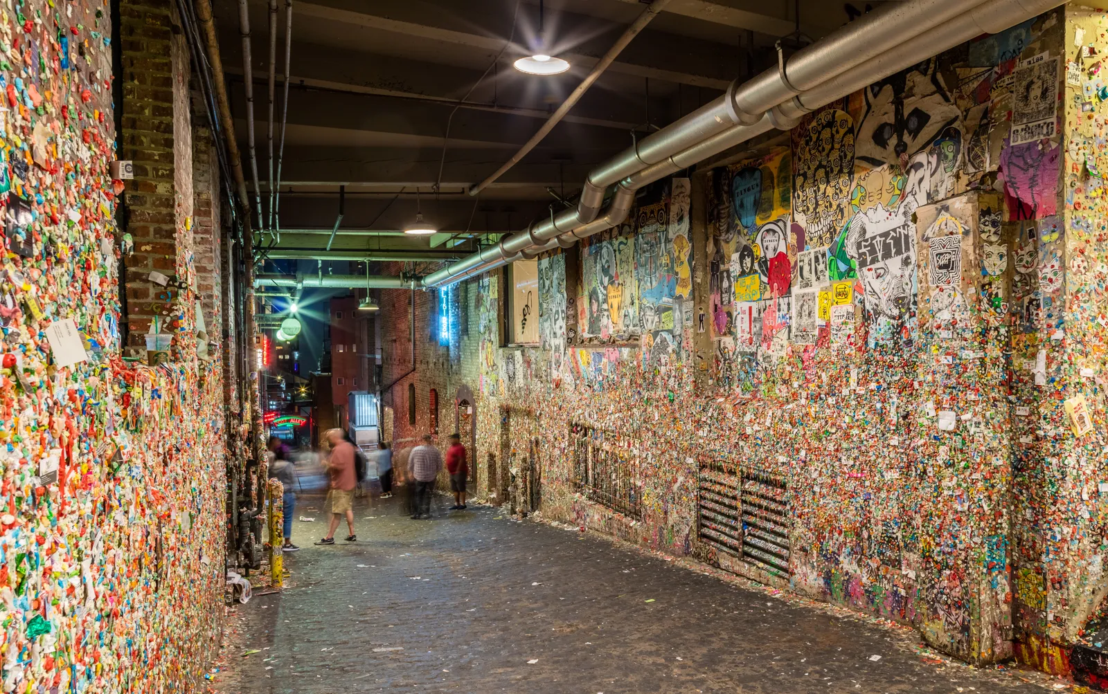 The gum wall in Post Alley below Pike Place Market, both brick walls of the passage caked in layers of chewed gum in every color