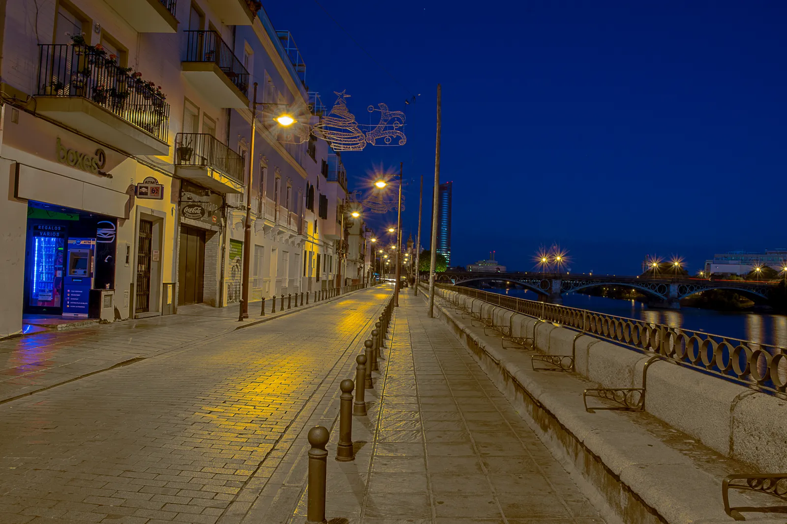 Riverfront buildings and promenade along Calle Betis in Seville