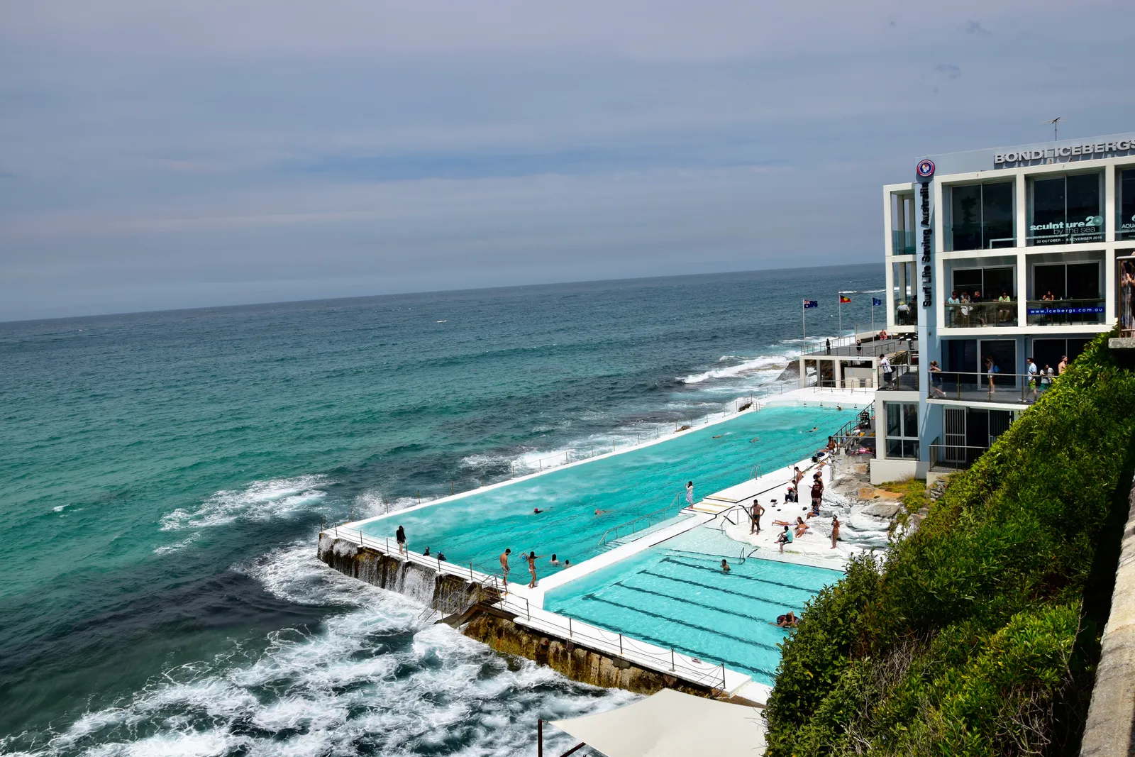The Bondi Icebergs ocean pool cut into the rocks at the south end of Bondi Beach, its lap lanes beside the surf with the white clubhouse above