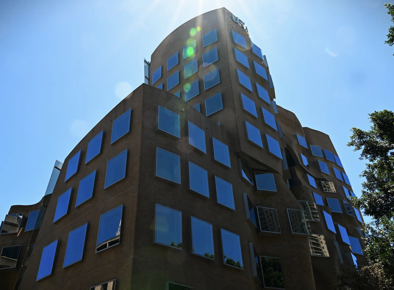 The Dr Chau Chak Wing Building in Ultimo, Sydney, its brown brick walls bulging and folding in waves around square windows