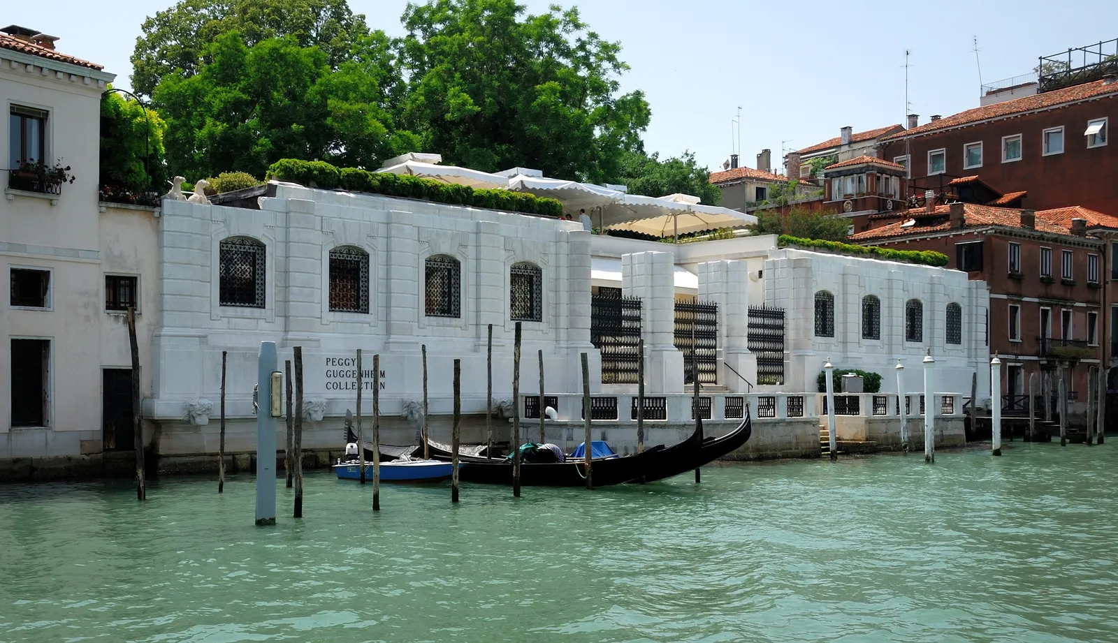 The low white Palazzo Venier dei Leoni on the Grand Canal, home to the Peggy Guggenheim Collection, with gondolas moored outside