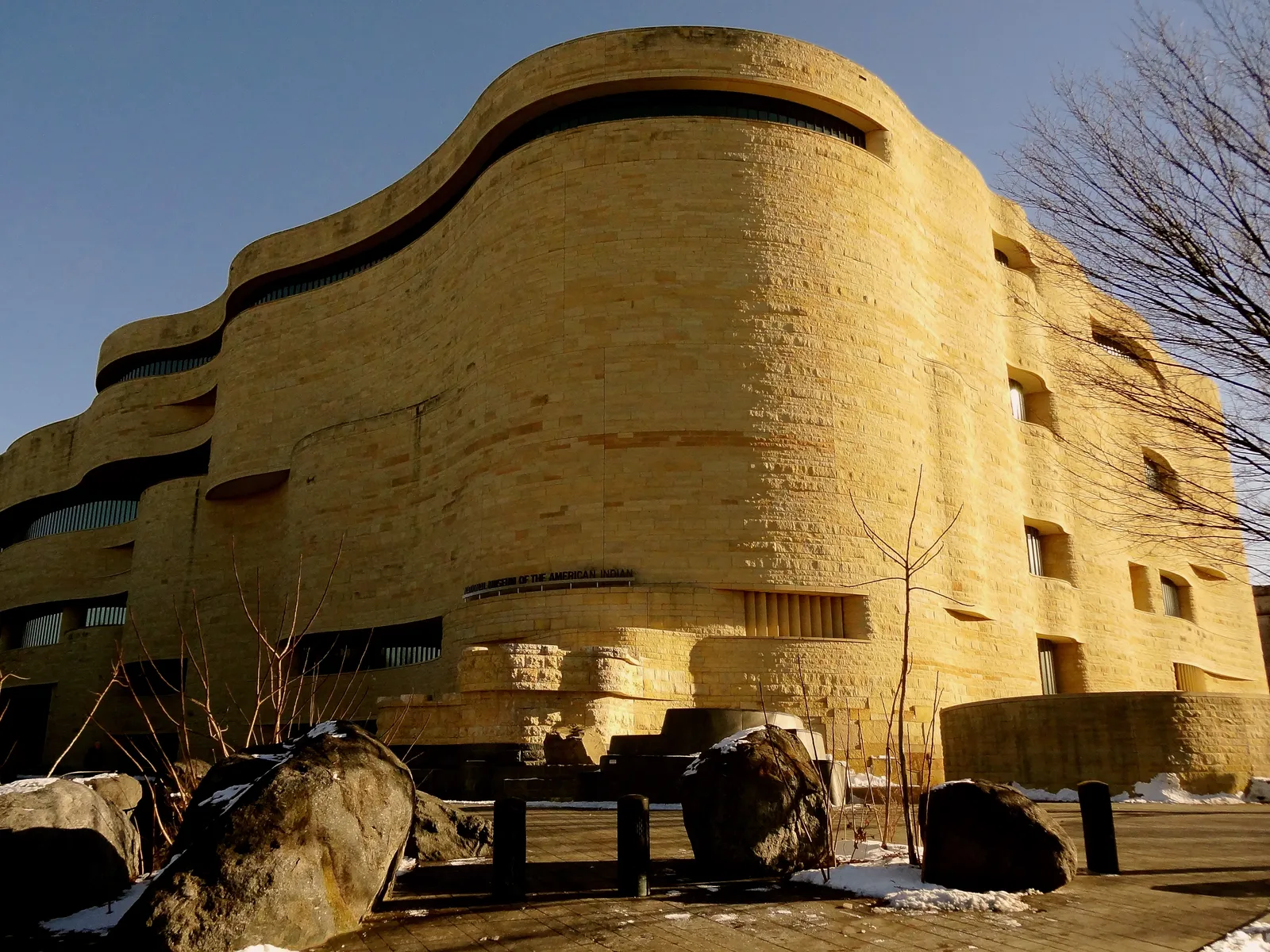 The National Museum of the American Indian in Washington, a five-storey building of golden limestone whose curved, layered walls are cut to look like wind-eroded rock
